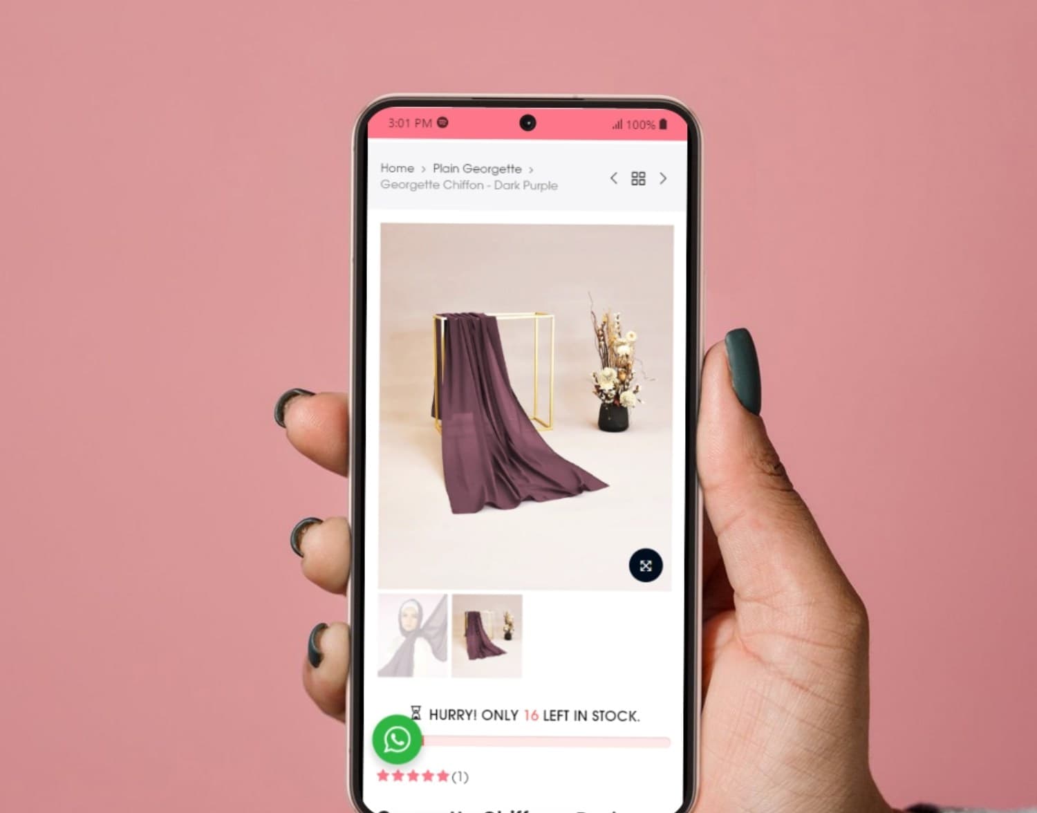 A hand holding a phone showing a Bloomscarfs product